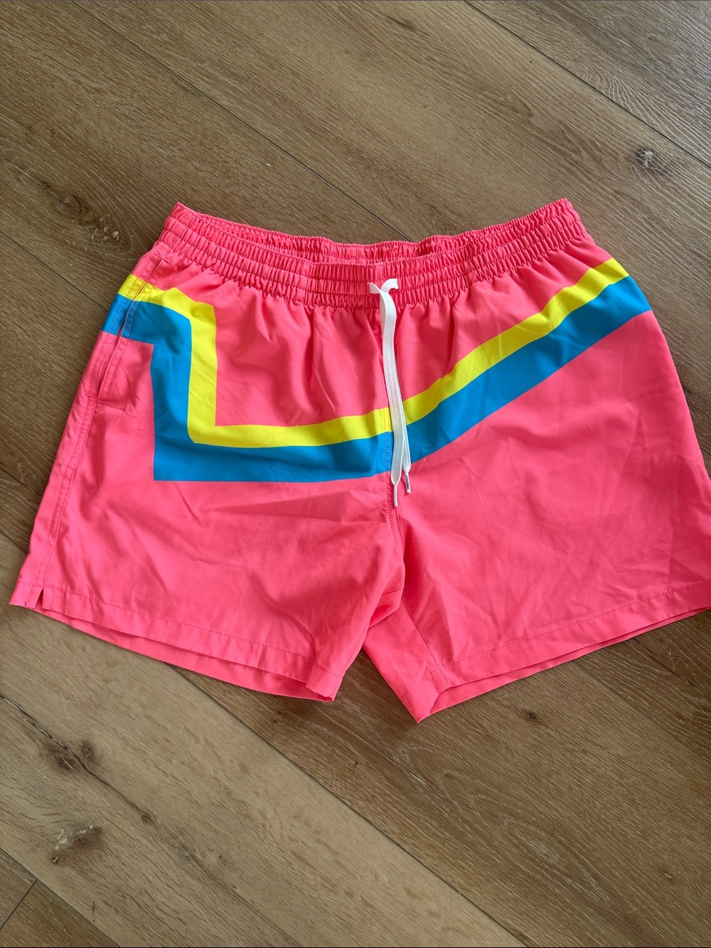 chubbies Neon Pink Swim Trunks with Blue and Yellow Stripe